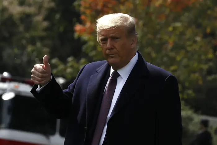 President Donald J. Trump offers a thumbs up to the media as walks on the South Lawn of the White House in Washington before his departure for a roundtable with supporters in Bedminster, New Jersey on Thursday, October 1.